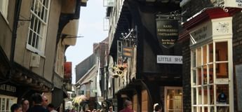 The Shambles on a busy day looking down to Little Shambles in York
