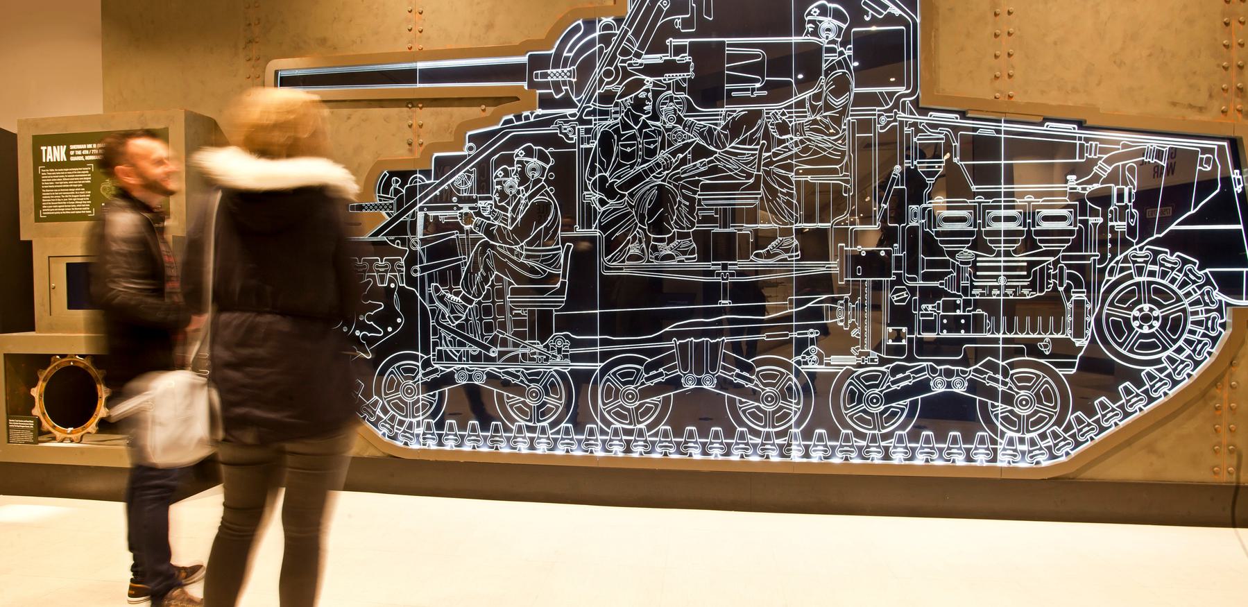 Two adults viewing York Army Museum Tank